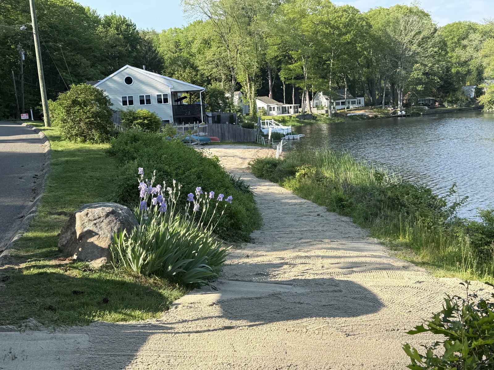 Iris-lined gravel pathway down to the water at Grass Island in Guilford