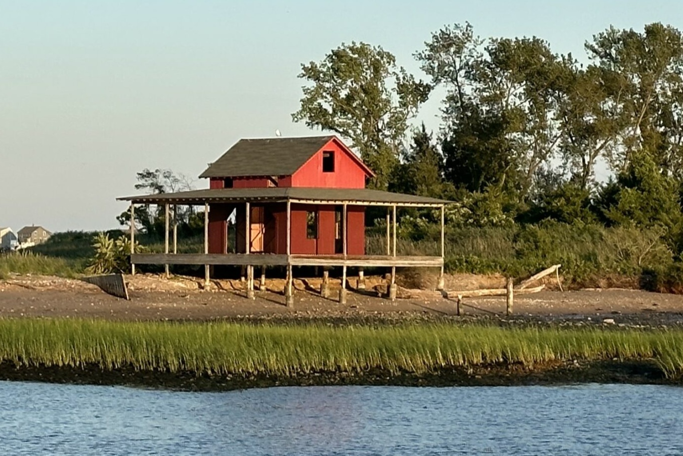 The Little Red Shack on Grass Island in Guilford, Connecticut — the iconic barn-red cottage on stilts above the marsh