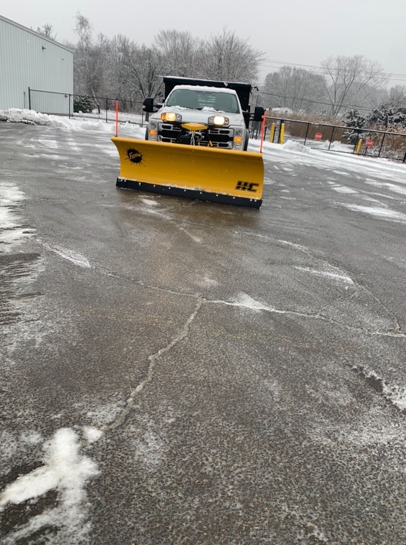 Country Hill plow truck clearing snow from a Connecticut Shoreline parking lot